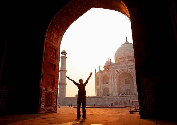 Western tourist excited to see Taj Mahal.